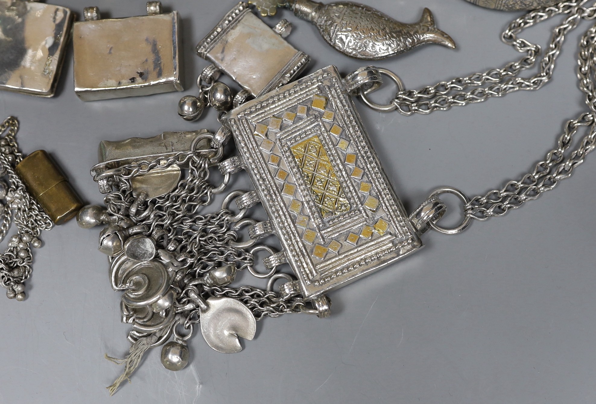 A small group of Middle Eastern mainly white metal jewellery, including bangles, bracelets and an Omani Hirz necklace.